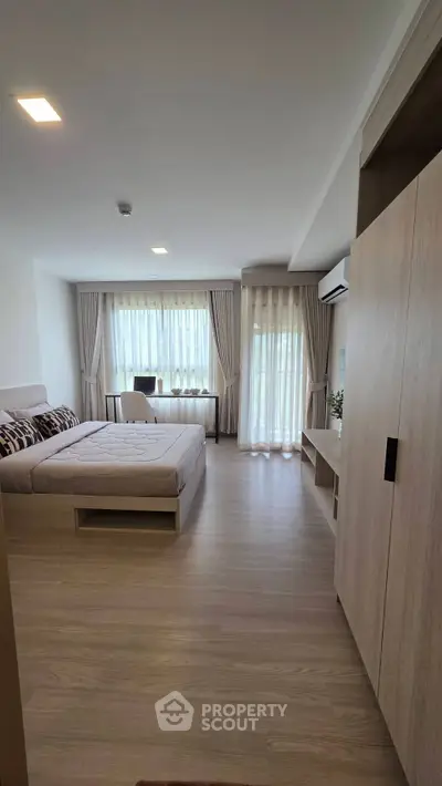 Spacious modern bedroom with large windows and elegant decor