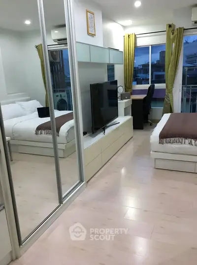 Modern bedroom with mirrored wardrobe and cozy workspace