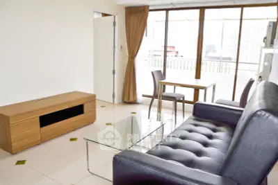 Spacious living room with modern furniture and large windows offering city views.