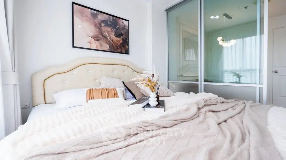Luxurious bedroom with elegant decor and cozy bedding in modern apartment.