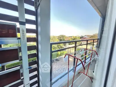 Charming balcony with scenic view and modern railing, perfect for relaxation.