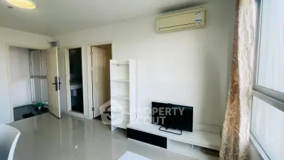 Modern living room with air conditioning and sleek white furniture, perfect for comfortable urban living.