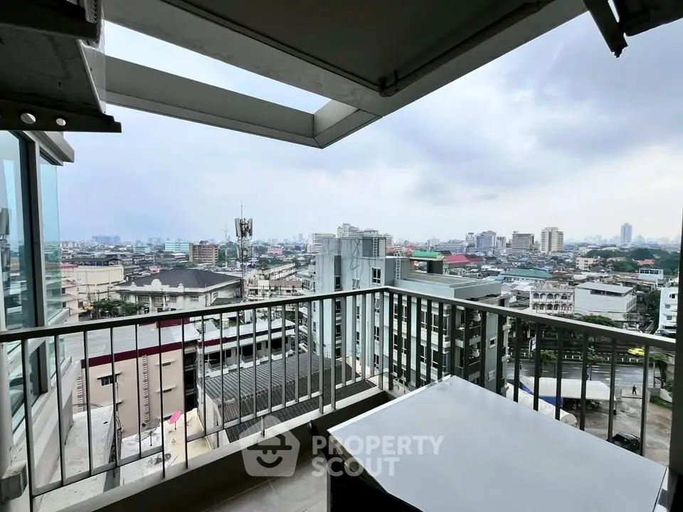 Stunning cityscape view from a modern balcony in a high-rise building.