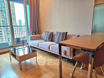 Modern living room with cozy sofa and city view balcony, perfect for urban living.