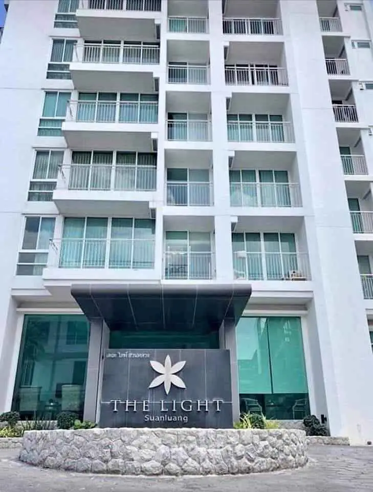 Modern condominium building exterior with sleek design and large windows at The Light Suanluang.