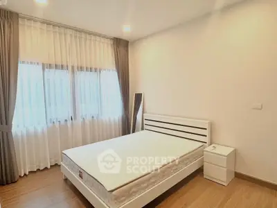 Spacious modern bedroom with natural light and elegant decor