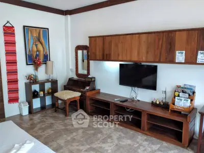 Charming living room with wooden furniture and modern decor, perfect for cozy relaxation.
