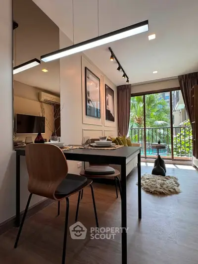 Modern living room with stylish decor and pool view from balcony