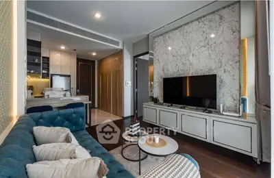 Luxurious modern living room with elegant marble accents and open kitchen layout.