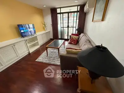 Cozy living room with modern decor and balcony access in urban apartment