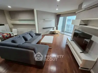 Spacious modern living room with sleek furniture and balcony access