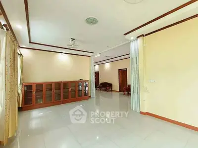 Spacious living room with elegant cabinetry and large windows