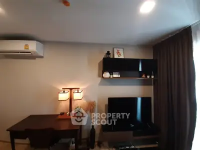 Modern living room with stylish decor, wall-mounted TV, and cozy lighting.