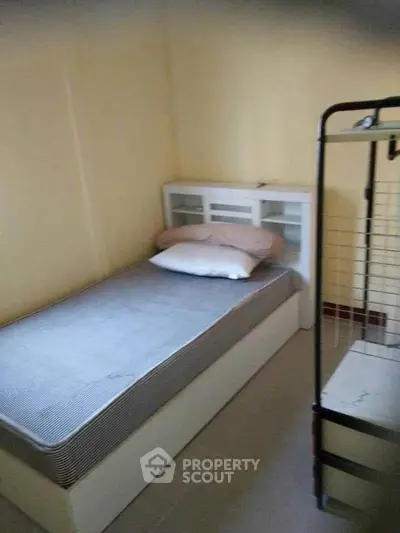 Cozy single bedroom with minimalist design and ample storage space, perfect for a compact living area.