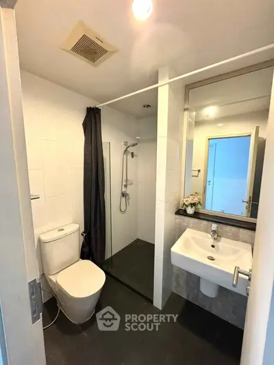 Modern bathroom with sleek fixtures and glass shower enclosure