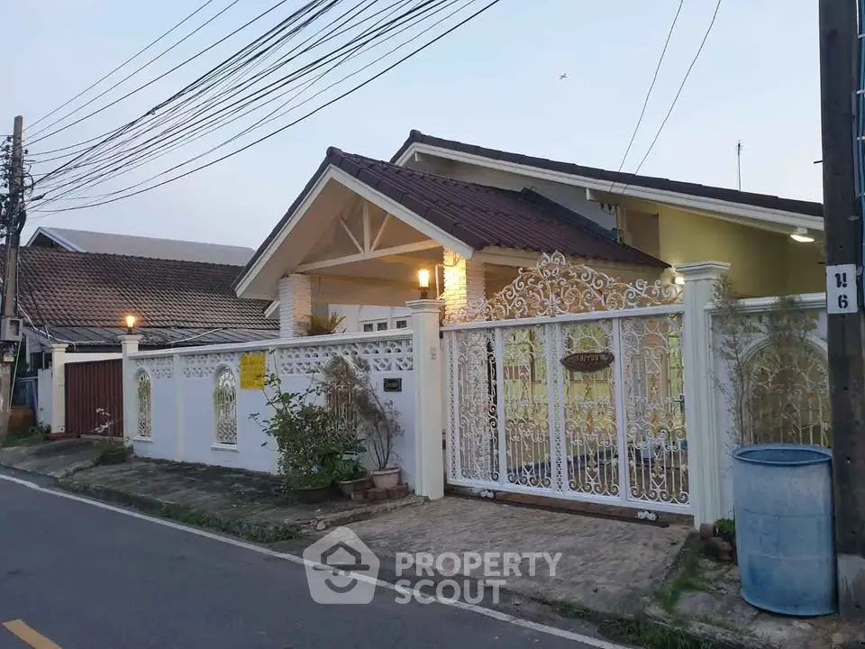 Charming suburban house with ornate gate and cozy front yard