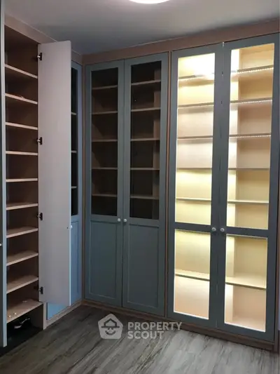 Spacious walk-in closet with elegant shelving and ample storage space.