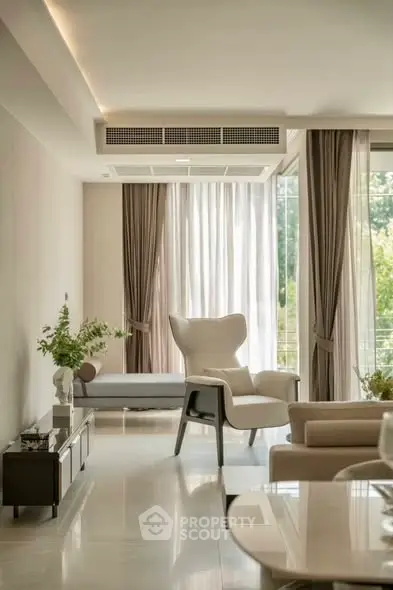 Luxurious modern living room with elegant furniture and large windows.