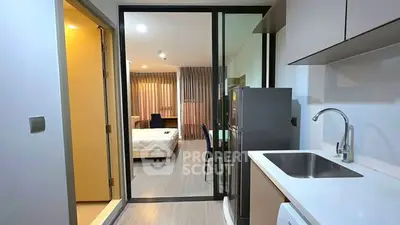Modern studio apartment with sleek kitchen and cozy bedroom