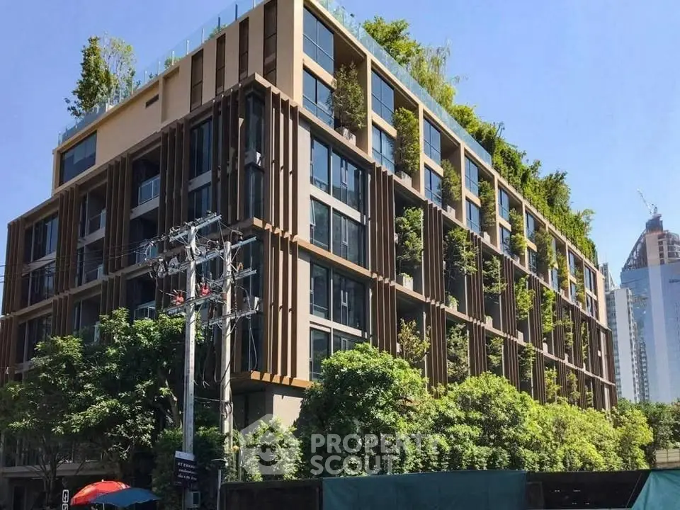 Modern eco-friendly building with lush greenery and urban skyline view