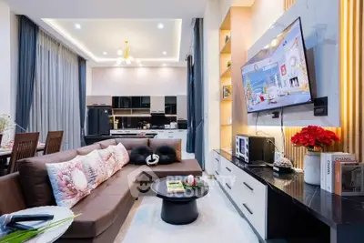 Modern open layout living room with stylish decor and kitchen view