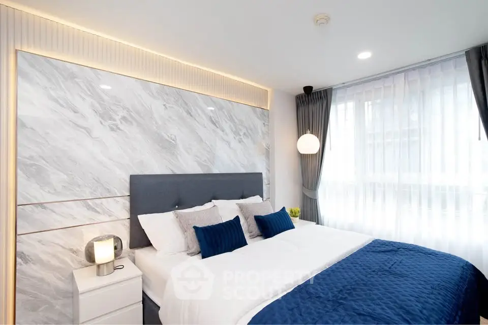 Luxurious bedroom with elegant marble accent wall and modern decor
