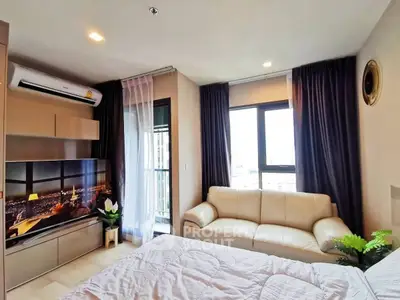 Modern bedroom with city view, cozy sofa, and stylish decor