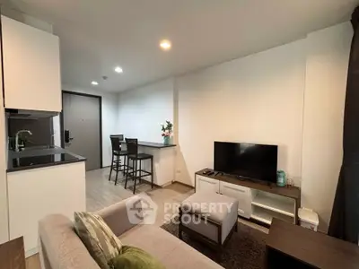 Modern living room with open kitchen layout and stylish decor
