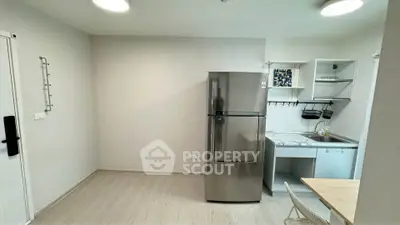 Modern kitchen with sleek fridge and compact dining area
