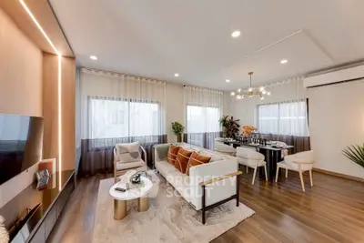 Elegant modern living room with stylish decor and dining area, featuring hardwood floors and natural light.