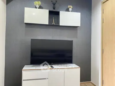 Modern living room with sleek TV stand and wall-mounted cabinet