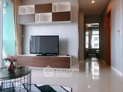 Modern living room with sleek TV unit and stylish decor in a bright apartment.