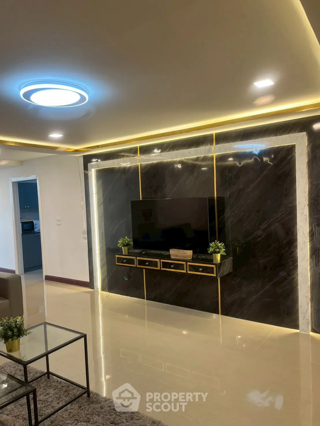 Luxurious living room with modern lighting and sleek TV wall design.
