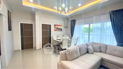 Modern living room with elegant dining area and stylish lighting