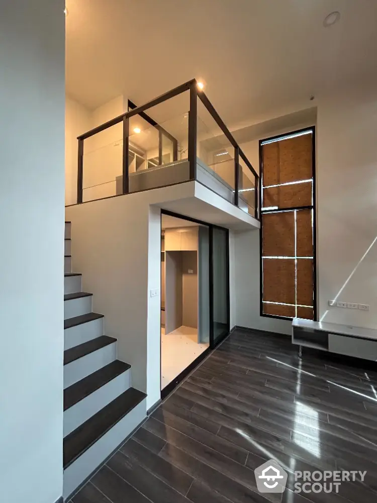 Modern duplex interior with sleek staircase and high ceilings