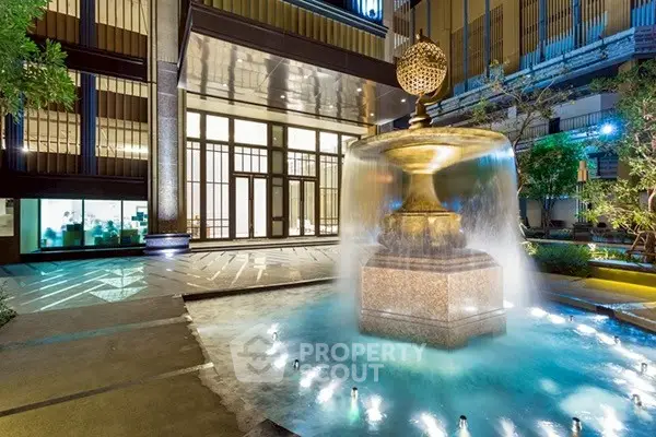 Luxurious building entrance with elegant fountain and ambient lighting