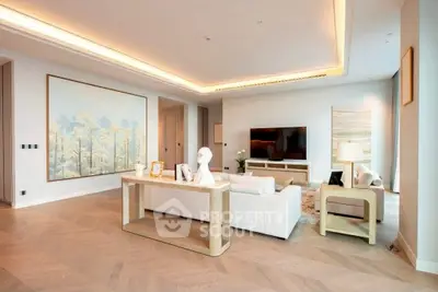 Luxurious modern living room with elegant decor and large artwork, perfect for relaxation.