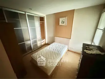Cozy bedroom with minimalist design and ample storage space