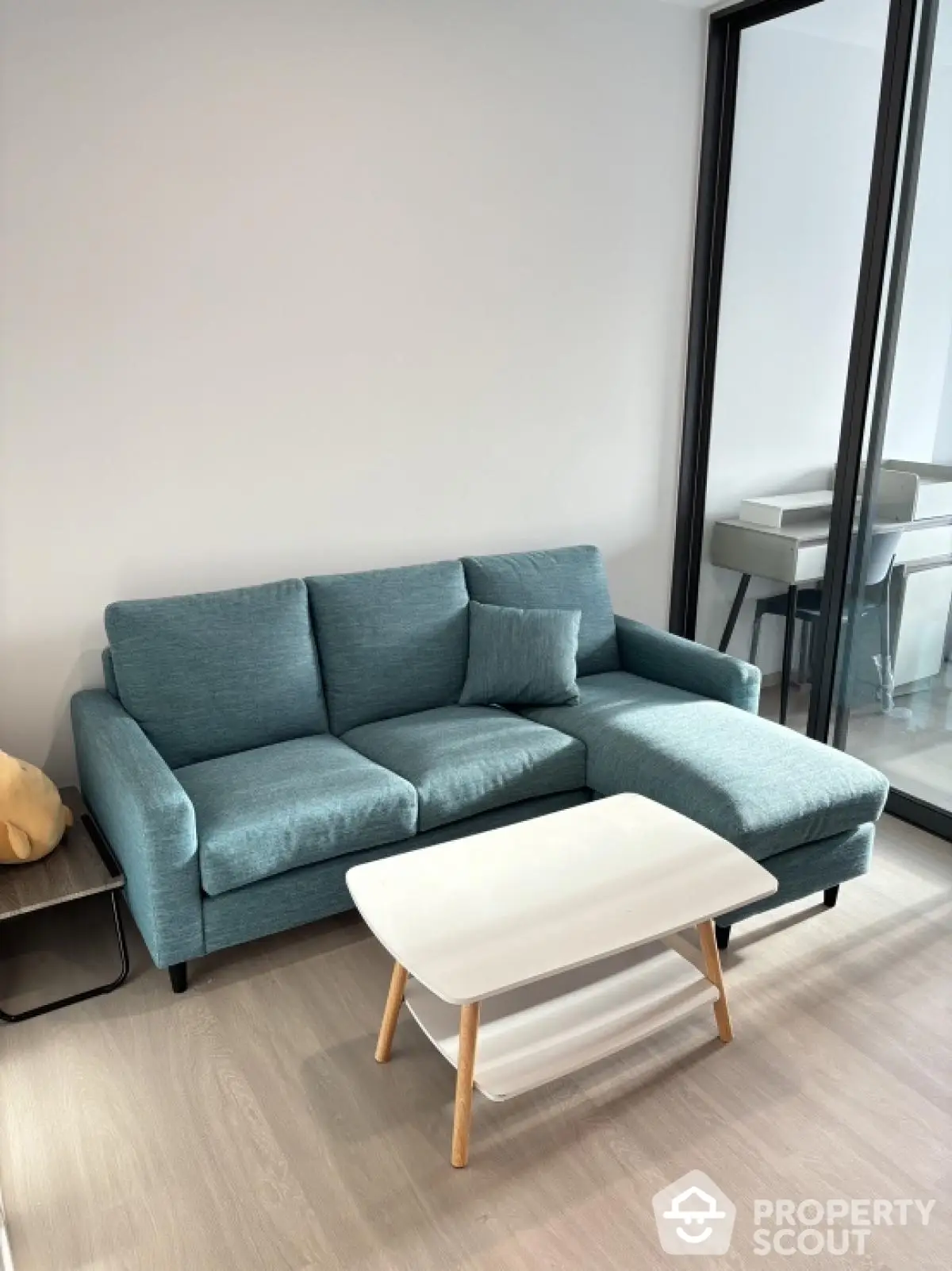 Modern living room with stylish blue sofa and sleek coffee table