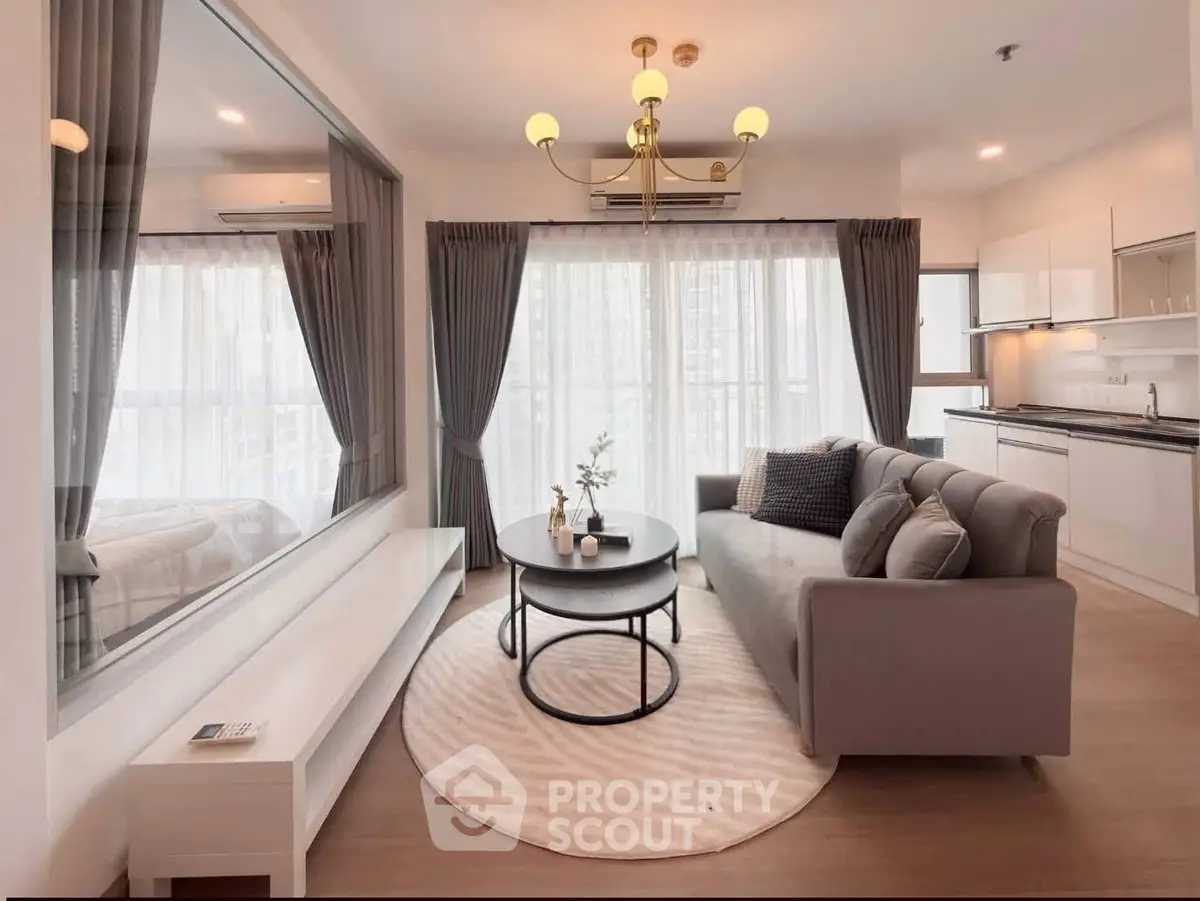 Modern living room with elegant decor and large windows in a stylish apartment.