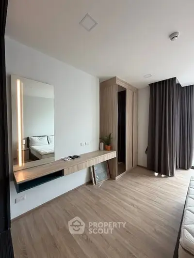 Modern bedroom with sleek wooden flooring and stylish wardrobe design