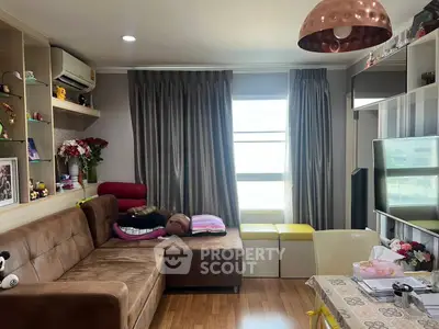 Cozy living room with brown sofa and modern decor, perfect for relaxation.