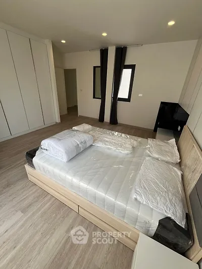 Spacious modern bedroom with sleek design and ample natural light