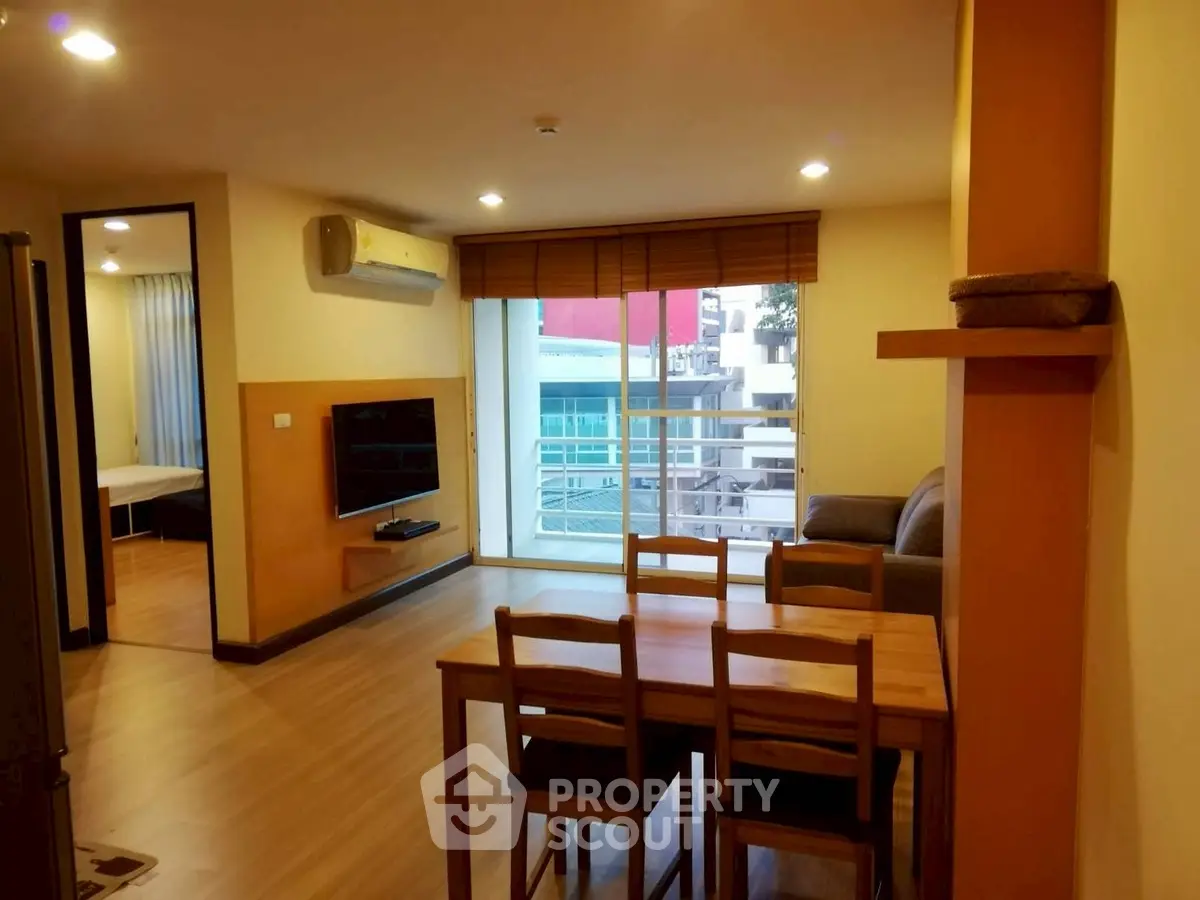 Spacious living room with modern decor and balcony view in urban apartment