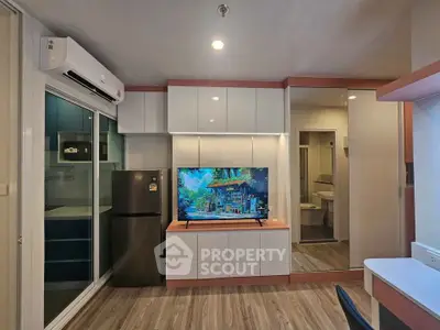 Modern living room with sleek design, featuring built-in cabinets, a large TV, and stylish flooring.