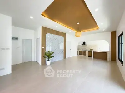 Spacious modern living room with open kitchen and stylish ceiling design