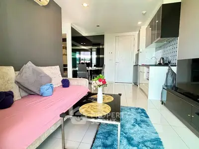 Modern living room with stylish decor and open kitchen layout in a cozy apartment.