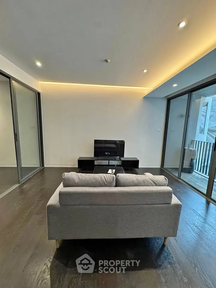 Modern living room with sleek design and balcony access