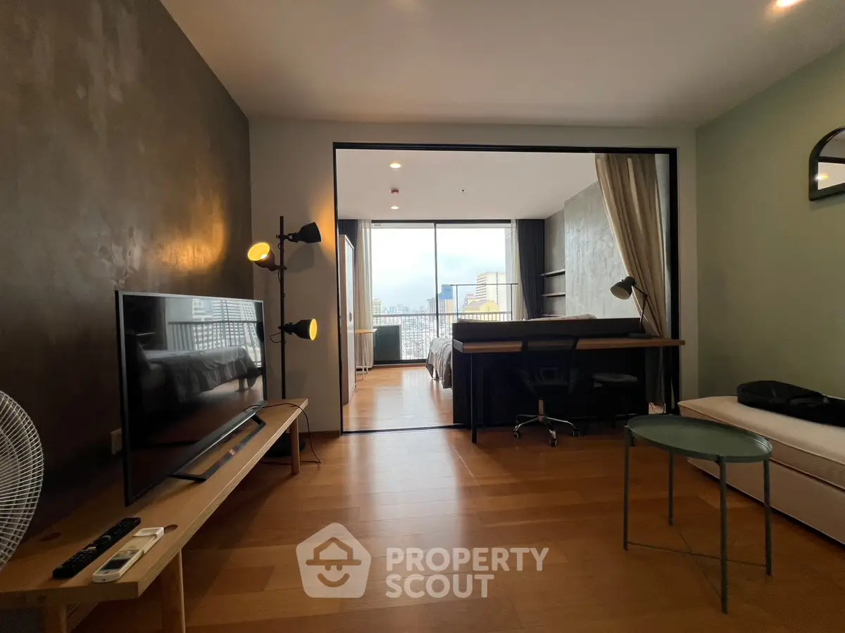 Modern studio apartment with open layout and city view, featuring stylish decor and natural light.
