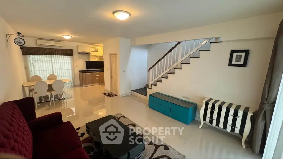 Spacious living room with modern furniture and open kitchen layout